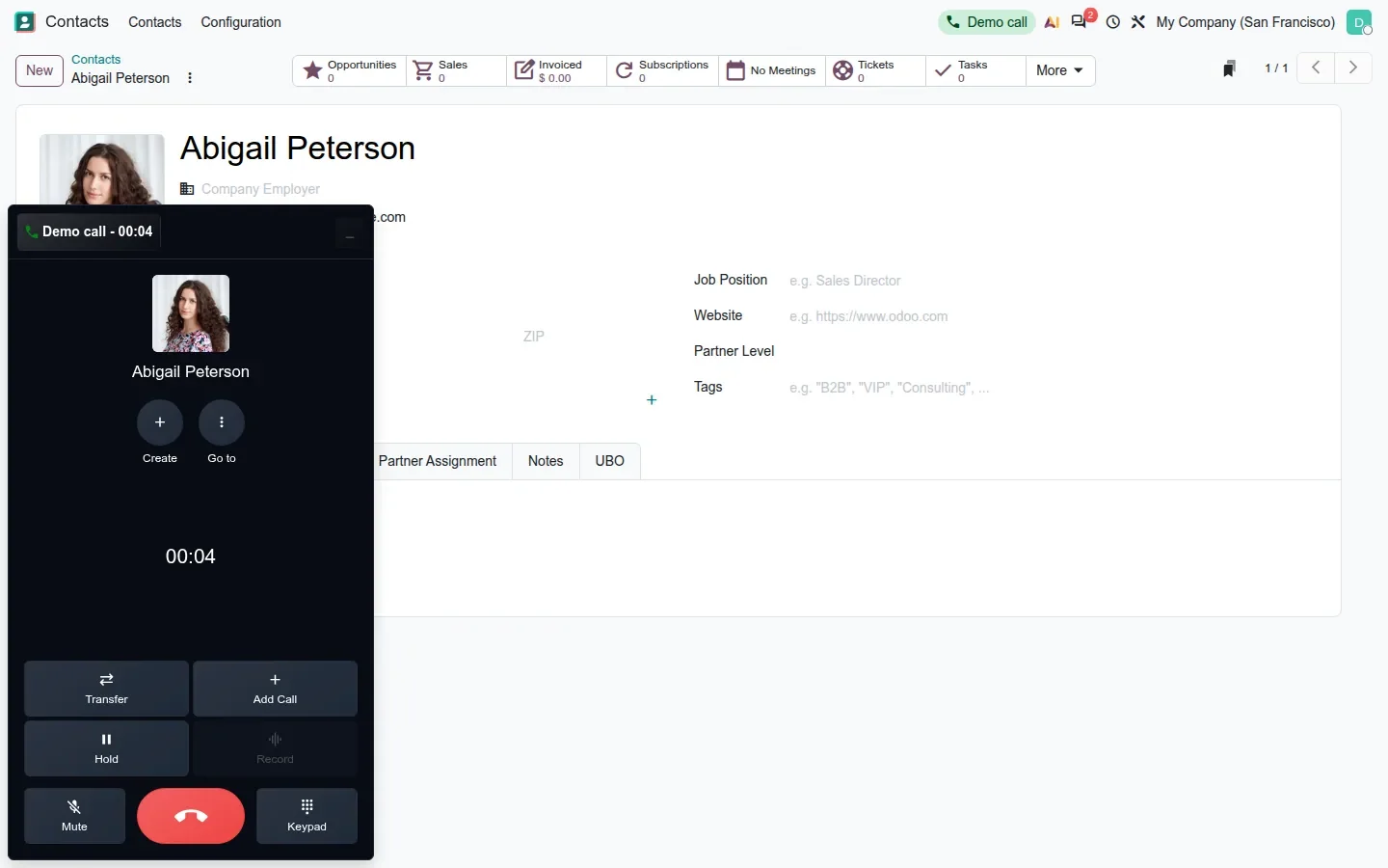 Dark softphone panel showing a call in progress with transfer, hold, mute and keypad buttons